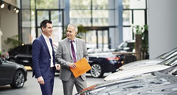 men-conversation-car-showroom