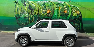 Hyundai INSTER in white parked in front of an urban mural