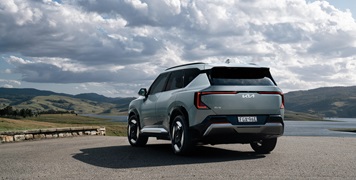 Kia EV5 Earth frost blue SUV parked overlooking NSW countryside lake and valley
