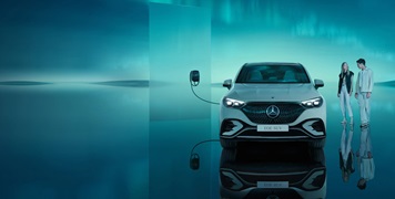 Moonscape featuring a Mercedes-Benz EQE SUV charging while a futuristically dressed couple stands beside the car.