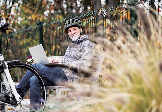 Cyclist sitting on park bench