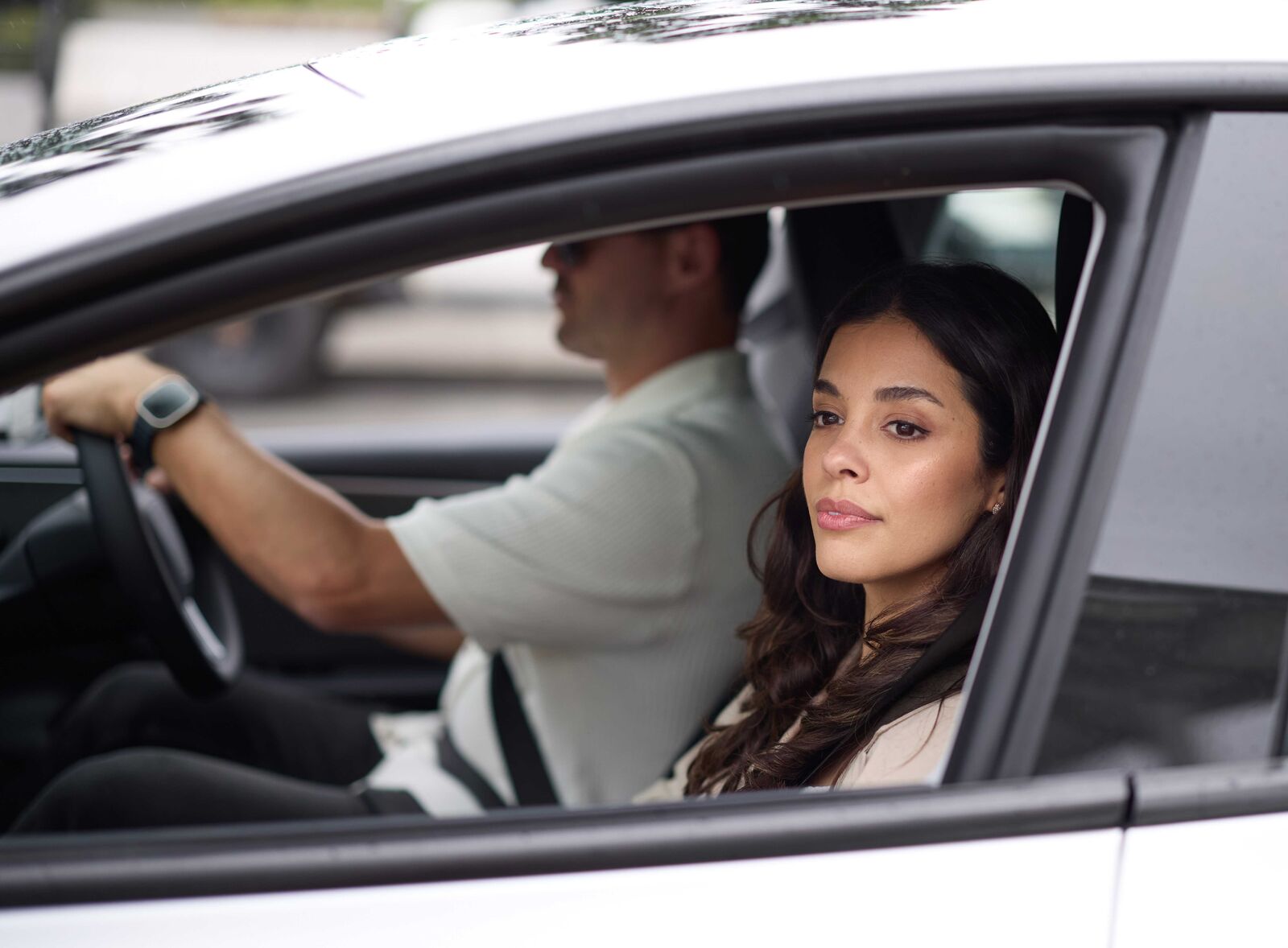 Two people driving in a vehicle