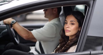 Two people driving in a vehicle