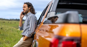 man standing next to ute