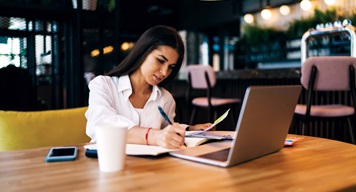 Kiwi woman working on a laptop in office