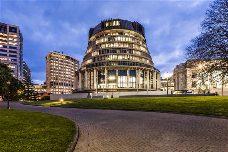 The Beehive building in Wellington, New Zealand, illuminated at dusk—symbolising government partnerships in sustainable fleet management and vehicle leasing services.