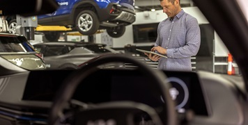 Mechanic reviewing tablet for vehicle service