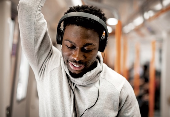 Man with headphones on public transport