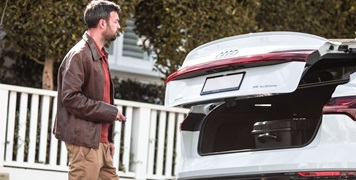 Man closing boot of car