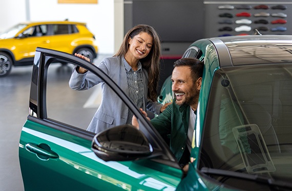 car-saleswoman-consulting-with-business-professional