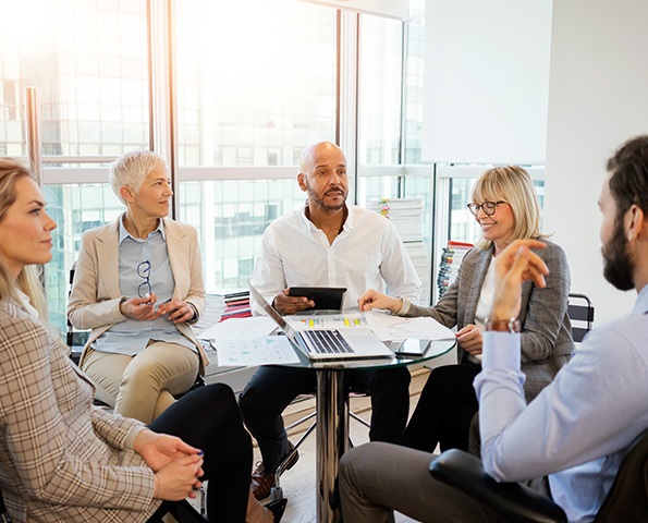 group-of-professionals-having-discussion-in-an-office-setting group-of-professionals-having-discussion-in-an-office-setting