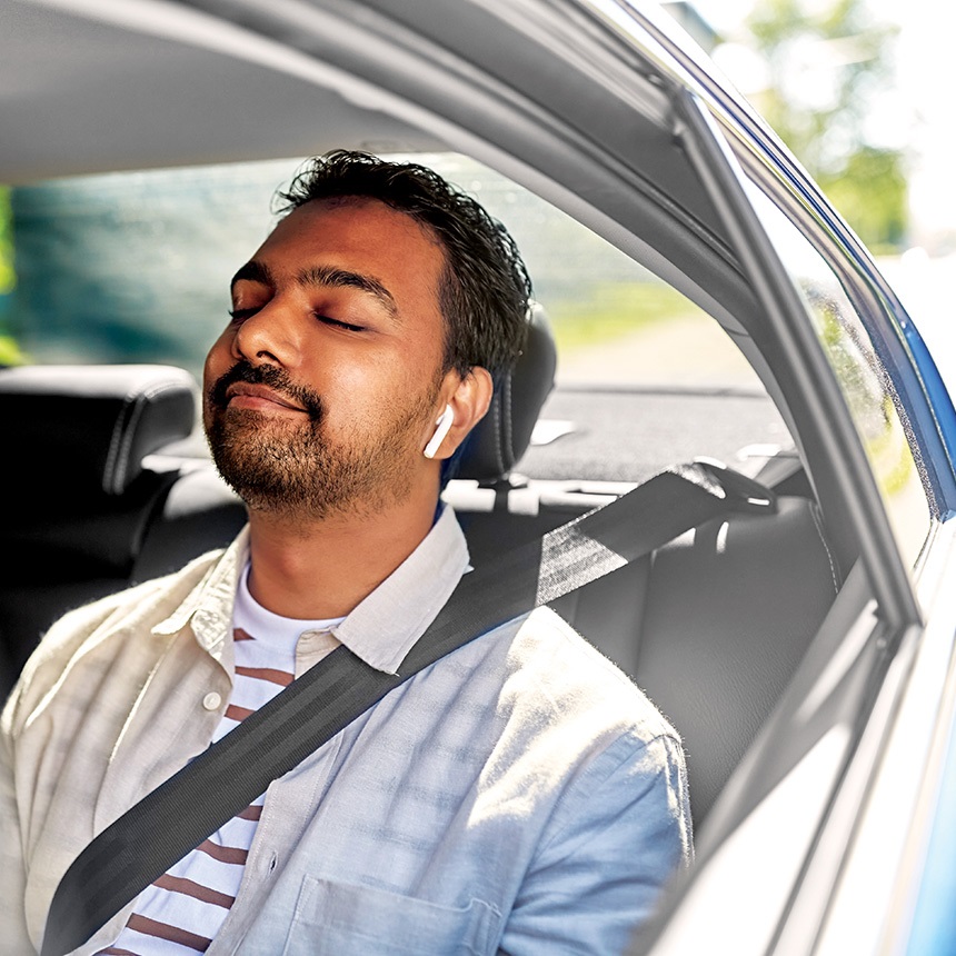 male-in-the-back-of-a-car-with-eyes-closed-smiling