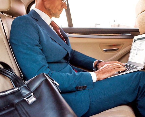 male-on-laptop-in-the-backseat-of-a-car male-on-laptop-in-the-backseat-of-a-car